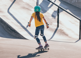 girl on skateboard wearing helmet