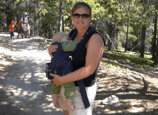 Mom on hiking trail with baby in carrier. Family Travel Tips. Des Moines Moms
