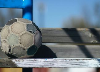 old soccer ball on bench. soccer mom. Des Moines Mom