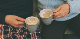 couple holding mugs with hot cocoa. winter date ideas