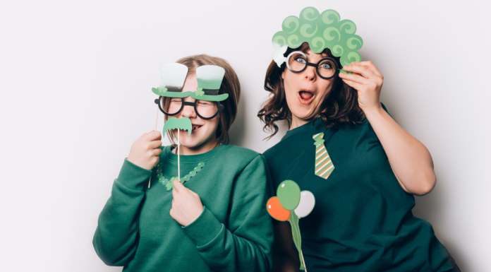 two people wearing green and holding St Patrick's Day things