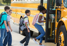 middle school kids getting on school bus